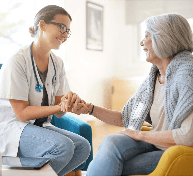 doctor talking with old woman in her house