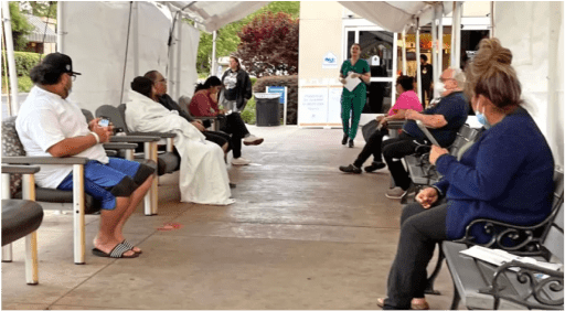 patients waiting in outdoor lobby